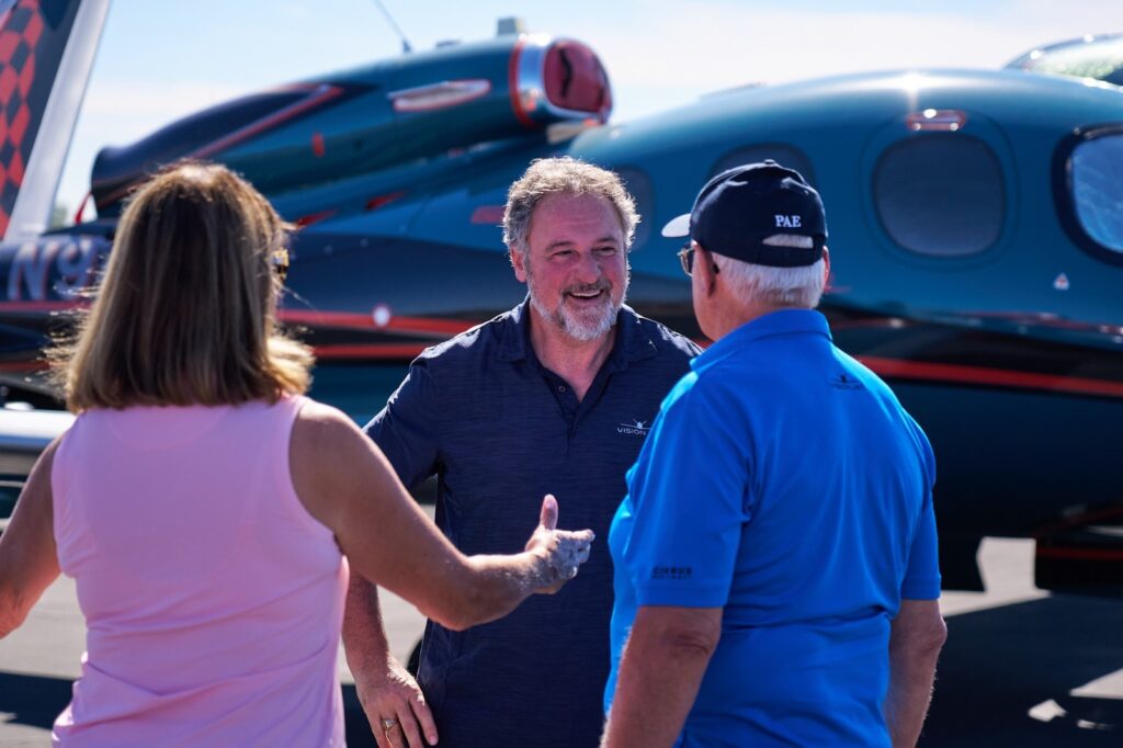 group of people in front of vision jet
