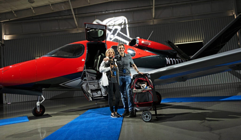 family standing in front of red vision jet