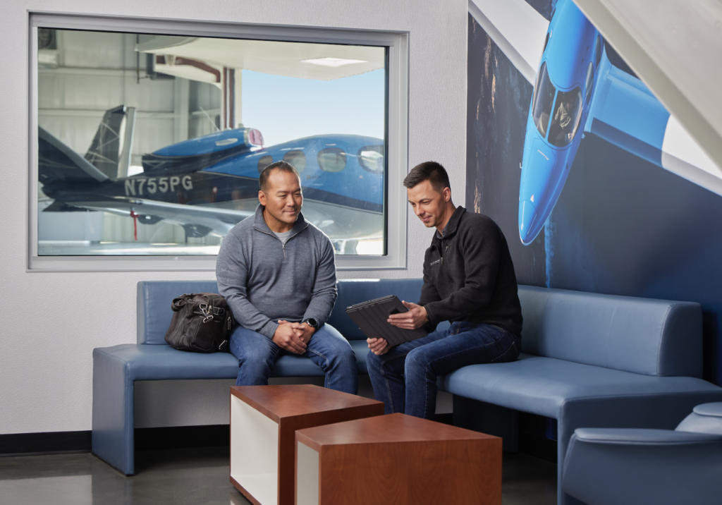 student and instructor at hangar